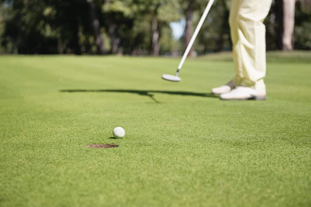 Close-up of golfer on putting green